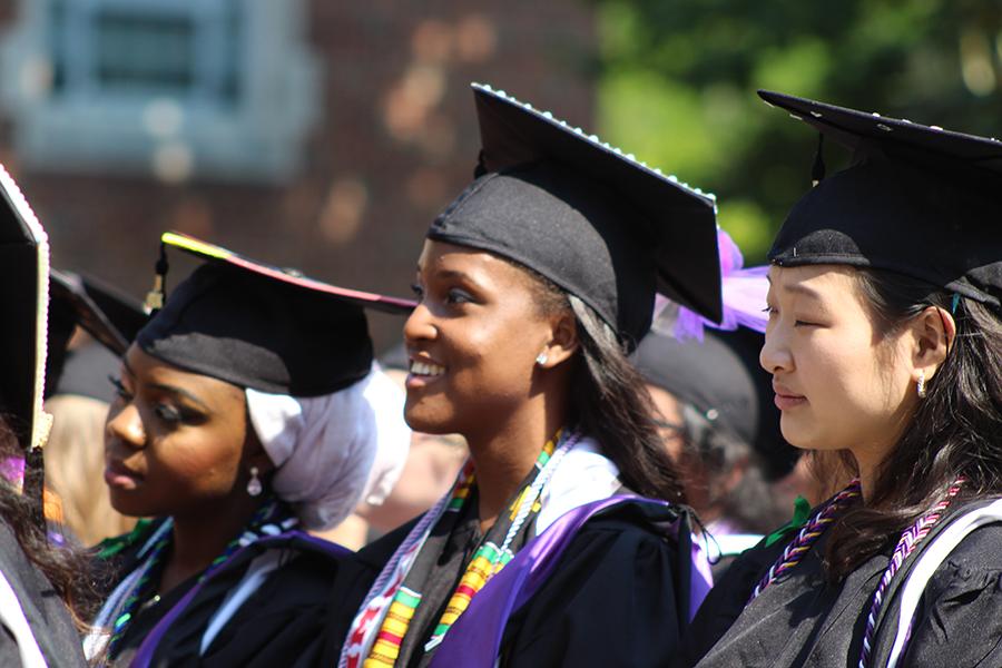 Several students wearing commencement caps and gowns.